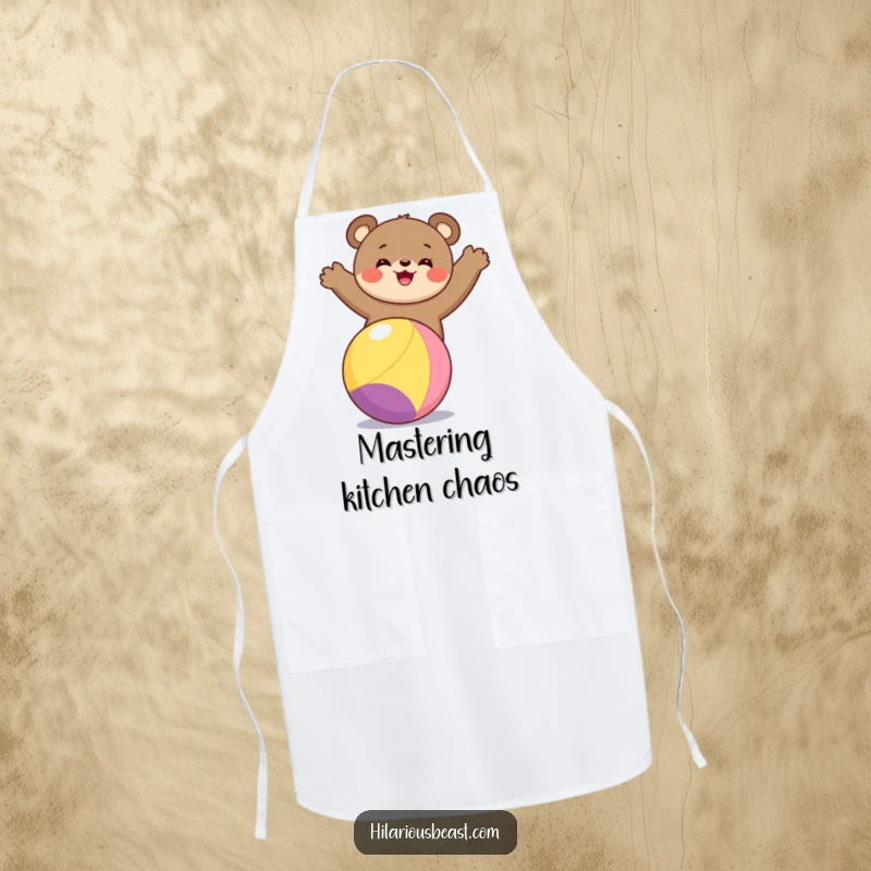 Funny bear cub apron showing a happy bear cub maintaining perfect balance on a colorful ball while ready to assist in the kitchen.