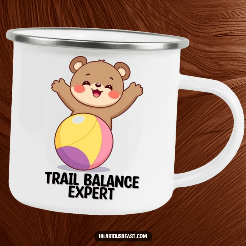 Funny bear cub camping mug featuring a delightful bear cub balancing on a colorful ball, perfect for sipping beverages in nature.