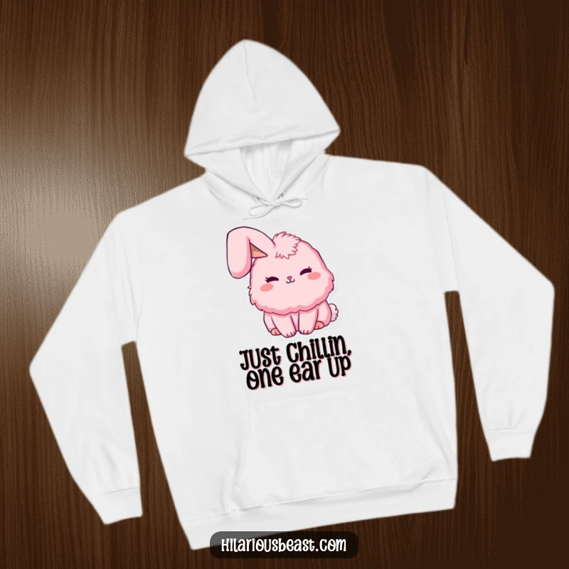 Funny fluffy pink bunny hoodie with a single ear playfully flopped over, creating a sweet and humorous look. Cozy and funny.