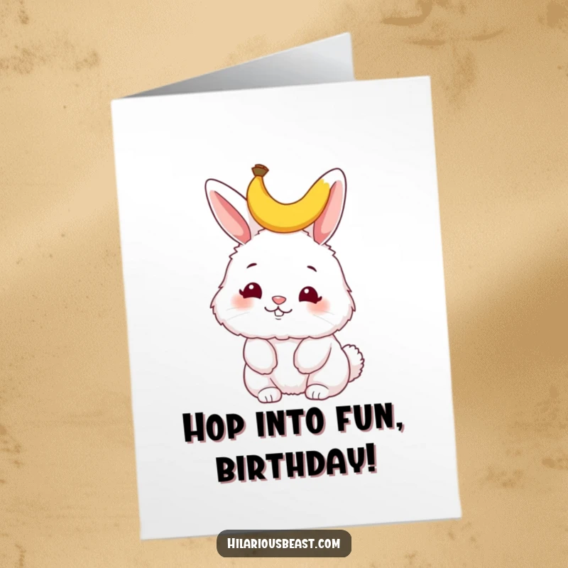 Funny Free Printable birthday card featuring a fluffy bunny wiggling its nose with a tiny banana peel perched humorously on its head.