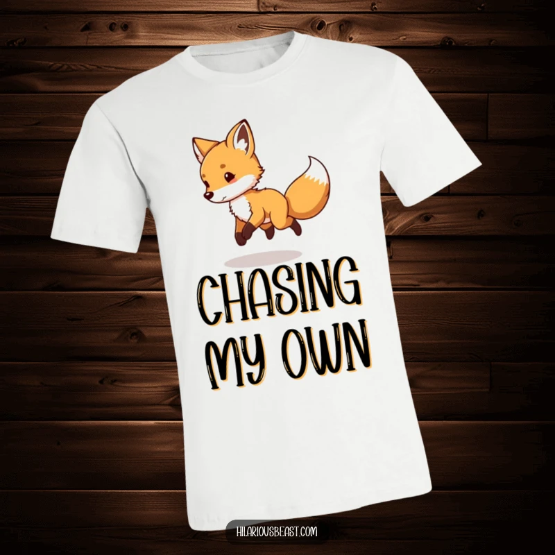 Funny Fox Cub T-Shirt: a mischievous little fox cub energetically chasing its tail in endless circles.