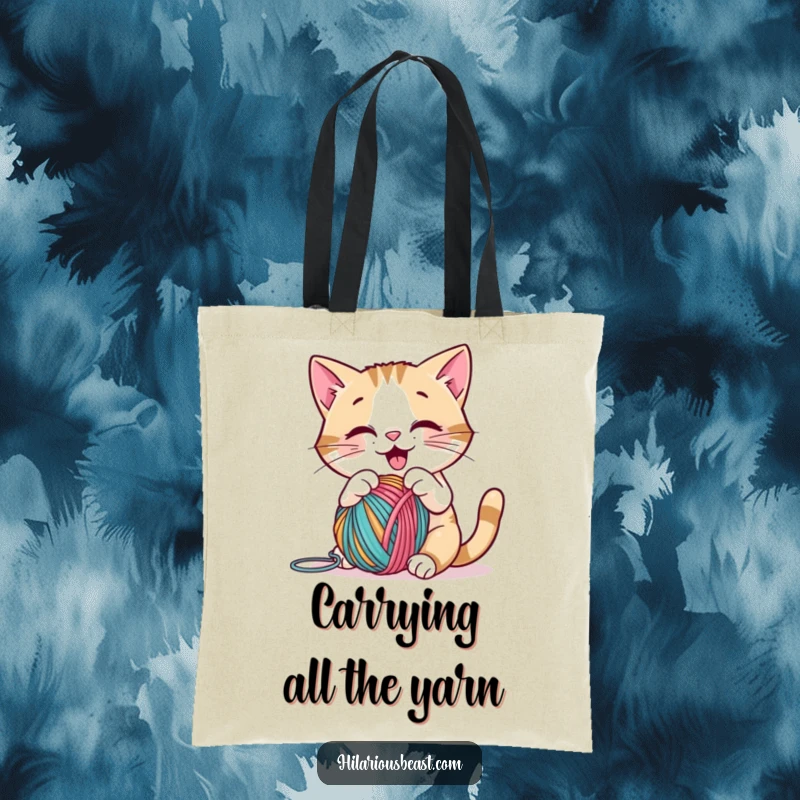 Funny cat batting a yarn ball on a tote bag, showcasing playful joy and making a great humorous funny gift.